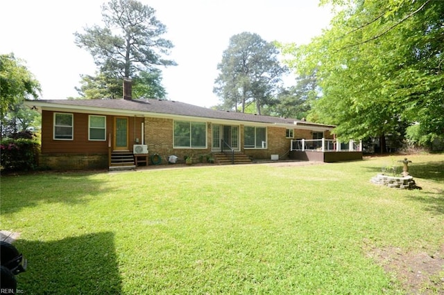 rear view of house featuring a lawn and a chimney