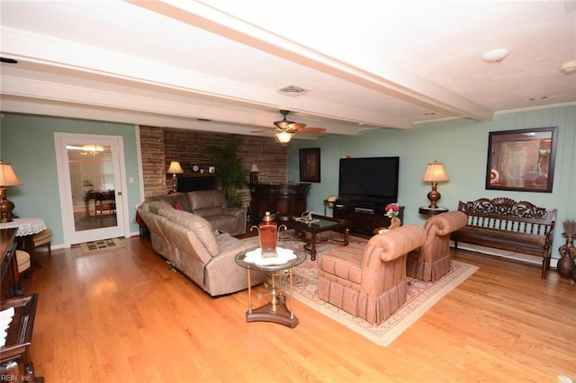living room with beam ceiling, a ceiling fan, wood finished floors, and visible vents