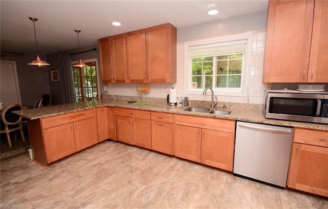kitchen featuring a sink, plenty of natural light, stainless steel appliances, and a peninsula
