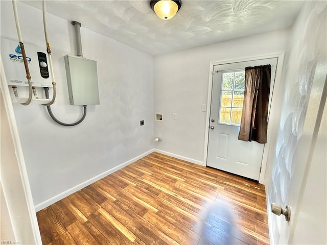 laundry room with laundry area, hookup for a washing machine, electric dryer hookup, baseboards, and hardwood / wood-style flooring