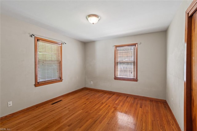 100 Hudgins Rd, Poquoson, VA 23662 - empty room with baseboards, wood finished floors, and visible vents