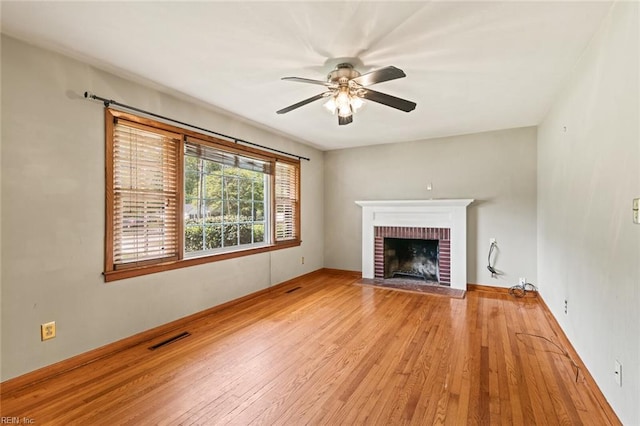 100 Hudgins Rd, Poquoson, VA 23662 - unfurnished living room featuring a fireplace, light wood-style floors, a ceiling fan, baseboards, and visible vents