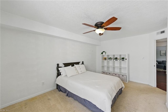 bedroom featuring a ceiling fan, baseboards, visible vents, and light carpet