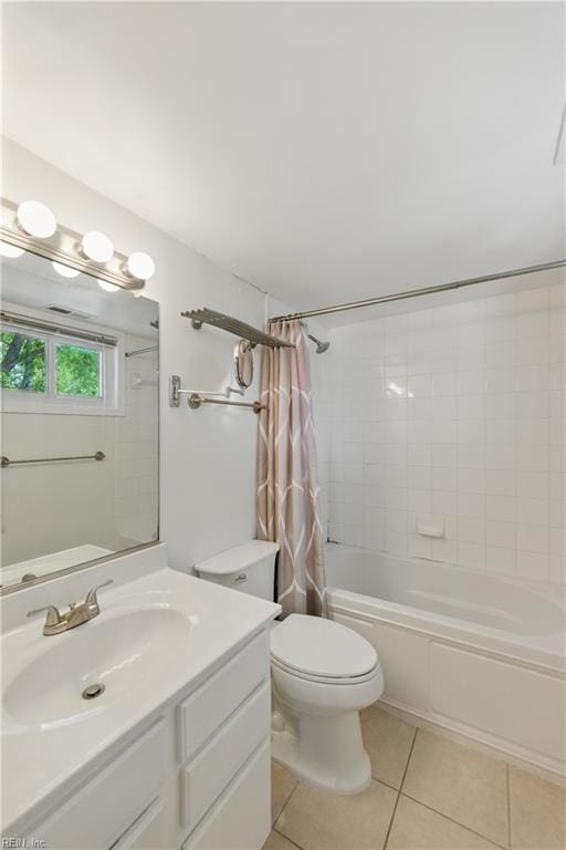 full bathroom with tile patterned floors, shower / bathtub combination with curtain, vanity, and toilet