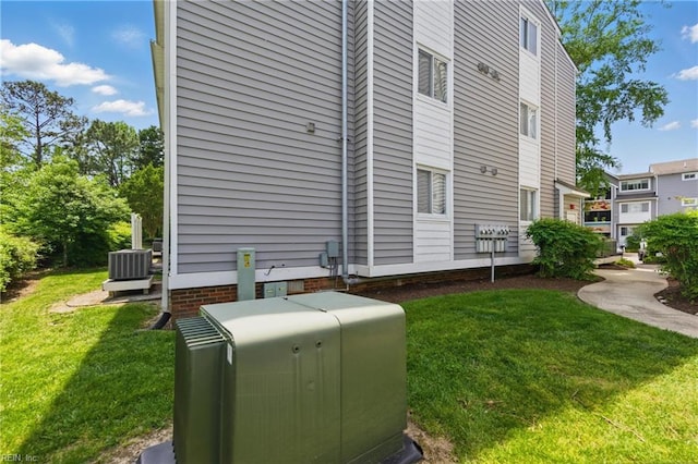 exterior space featuring a lawn and central air condition unit