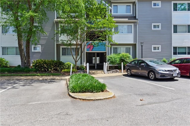 view of property featuring uncovered parking