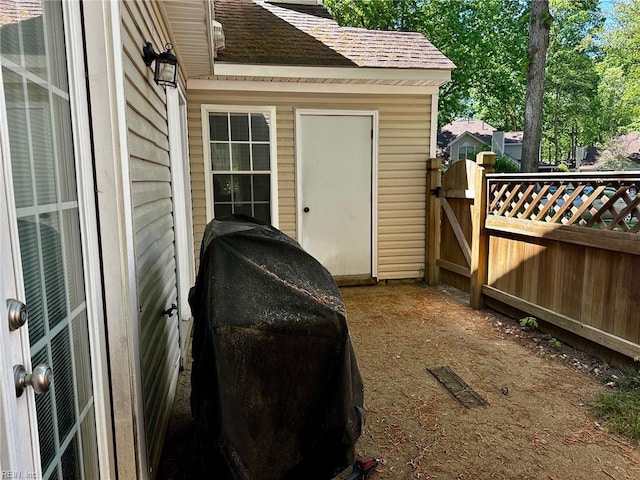 view of patio / terrace featuring fence, a gate, grilling area, and visible vents