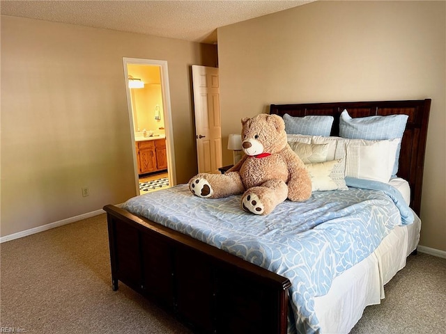 bedroom featuring baseboards, carpet flooring, a textured ceiling, and connected bathroom