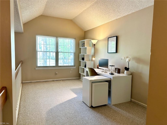 carpeted office space with baseboards, vaulted ceiling, a textured ceiling, and visible vents