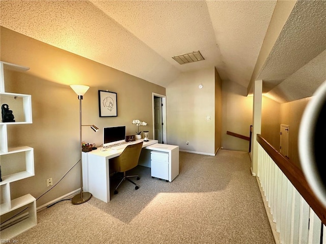 office area with baseboards, a textured ceiling, lofted ceiling, and light carpet