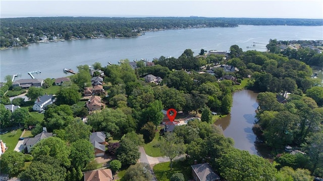 birds eye view of property with a water view, a residential view, and a forest view