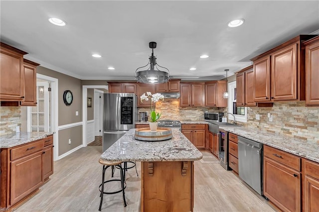 kitchen with wine cooler, a kitchen bar, a center island, tasteful backsplash, and appliances with stainless steel finishes