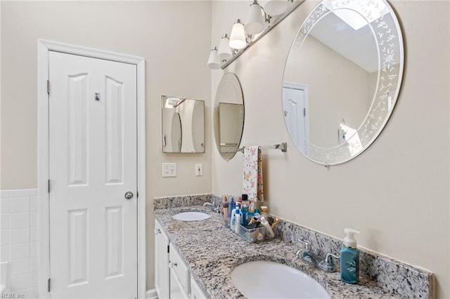 bathroom with a sink and double vanity