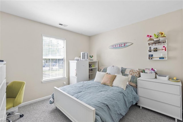carpeted bedroom featuring visible vents and baseboards