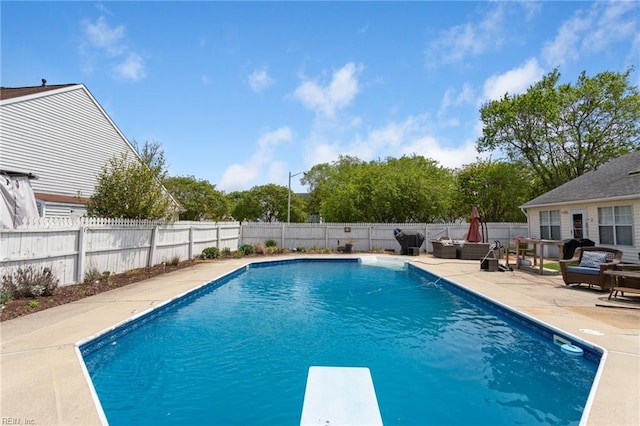 view of pool with a fenced in pool, a diving board, a fenced backyard, and a patio area