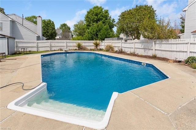 view of swimming pool with a fenced in pool, a fenced backyard, and a patio area