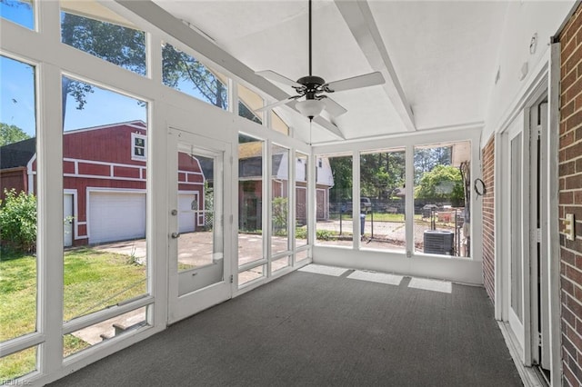 unfurnished sunroom with ceiling fan and a healthy amount of sunlight