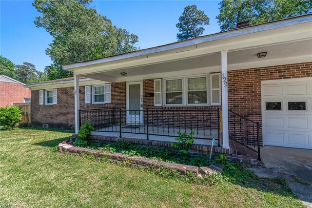 ranch-style home featuring a porch, a front lawn, and brick siding