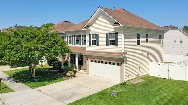 view of front of property featuring an attached garage, fence, driveway, and a front yard