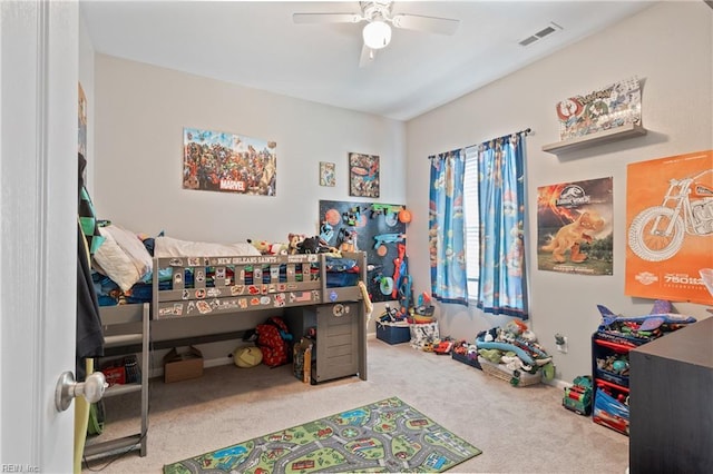 carpeted bedroom with a ceiling fan and visible vents