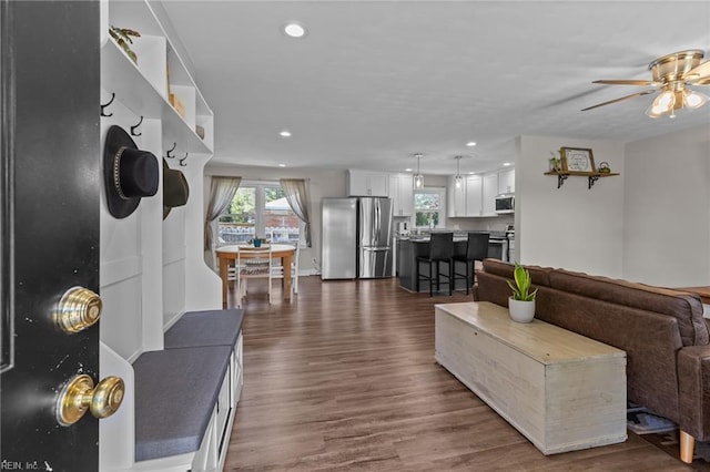 living area featuring recessed lighting, ceiling fan, and dark wood-style floors
