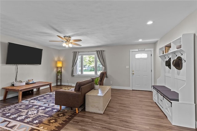 living room with baseboards, ceiling fan, recessed lighting, and wood finished floors