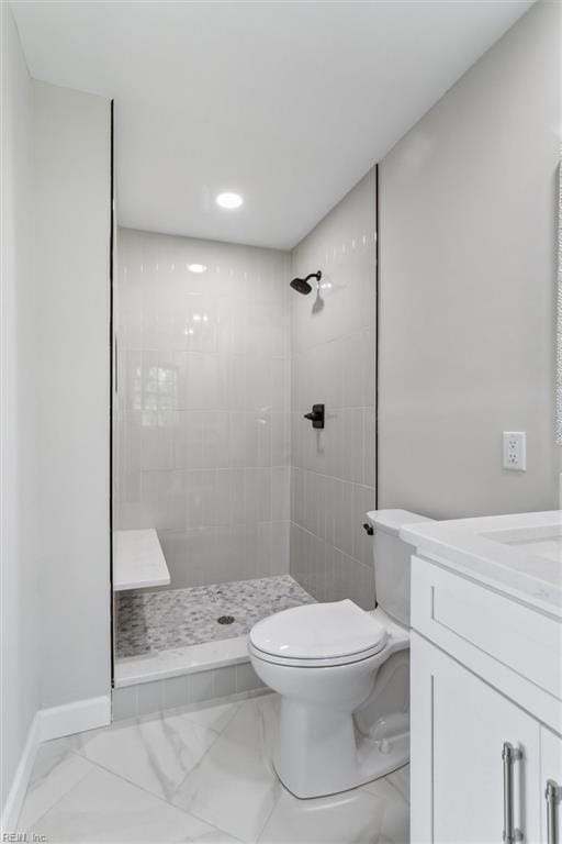 full bath featuring marble finish floor, toilet, and tiled shower