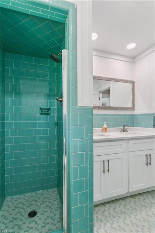 bathroom with vanity, a shower stall, and recessed lighting