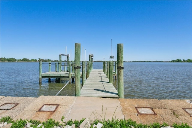 dock area with a water view and boat lift