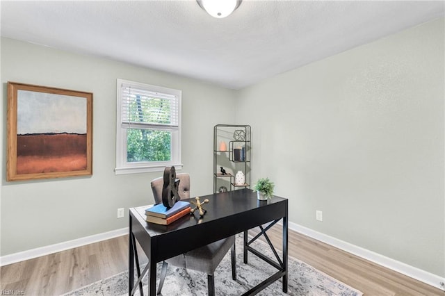 office space with light wood-style floors and baseboards