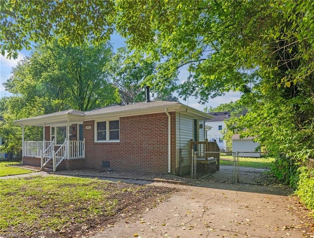 exterior space featuring brick siding, crawl space, and a gate
