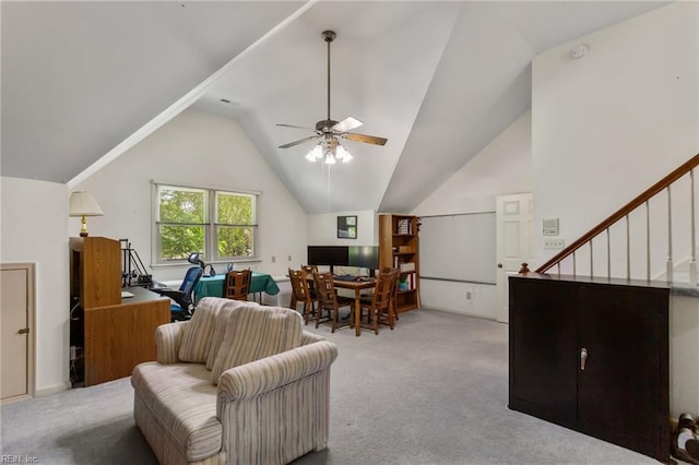 carpeted living area featuring stairs, a ceiling fan, and lofted ceiling
