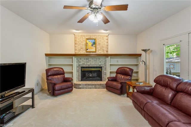 carpeted living room with a brick fireplace and ceiling fan
