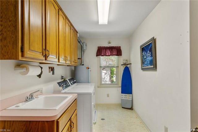 clothes washing area with washing machine and dryer, cabinet space, a sink, baseboards, and water heater
