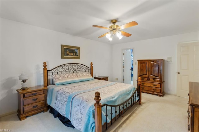 bedroom featuring ceiling fan, light colored carpet, and baseboards