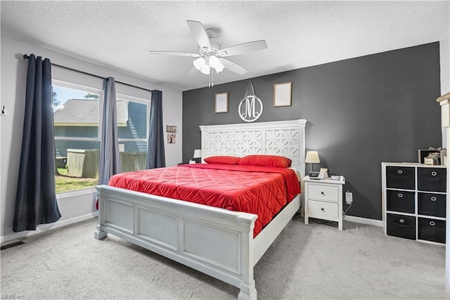 bedroom with baseboards, a textured ceiling, and carpet