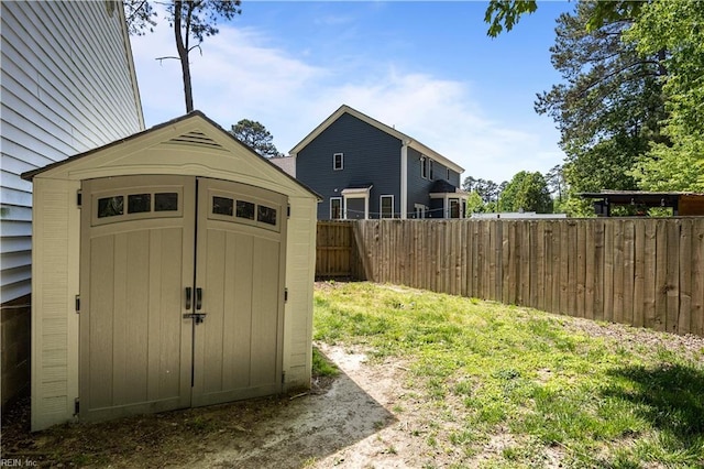 view of shed featuring fence