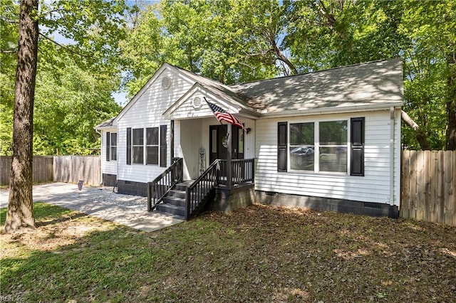 view of front of home with a fenced backyard and crawl space