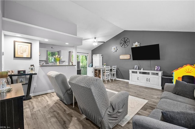 living room featuring a ceiling fan, baseboards, recessed lighting, wood finished floors, and lofted ceiling