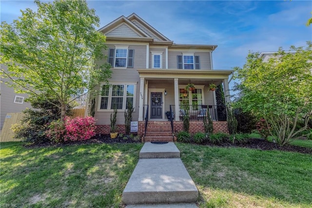 view of front of property with covered porch and a front yard