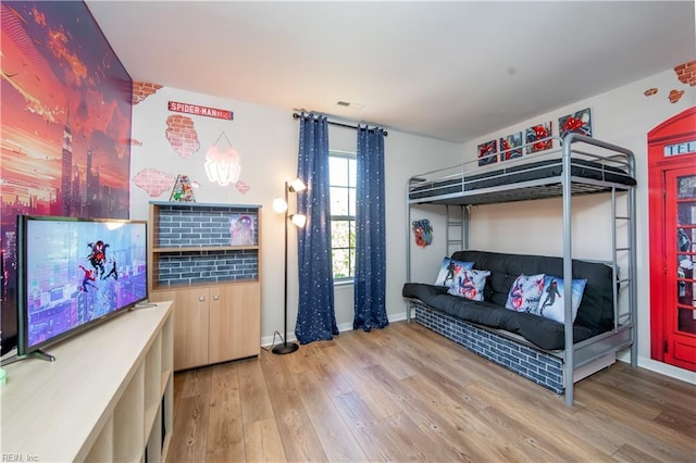 bedroom with baseboards and wood finished floors