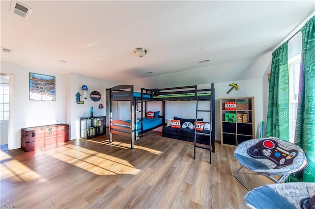 bedroom featuring visible vents and wood finished floors