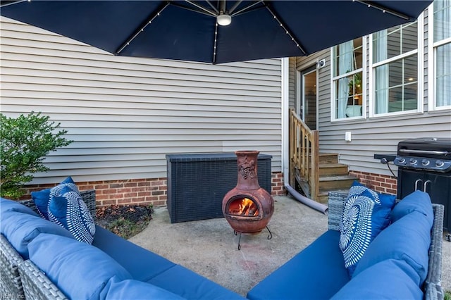 view of patio / terrace featuring an outdoor living space with a fire pit