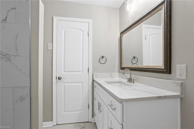 bathroom with vanity, baseboards, and marble finish floor