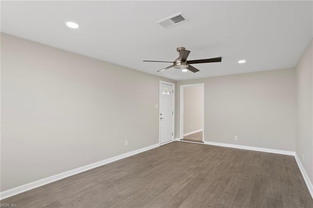 empty room with dark wood finished floors, a ceiling fan, baseboards, recessed lighting, and visible vents