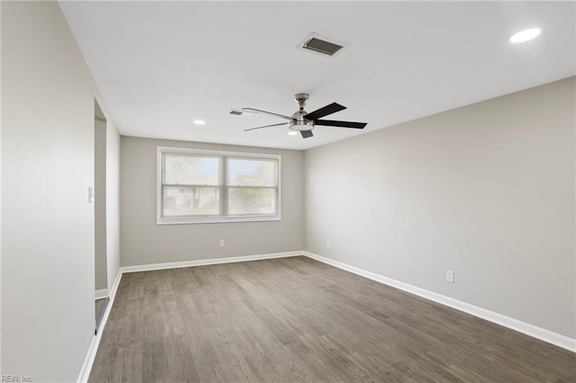 spare room featuring visible vents, baseboards, dark wood-style floors, recessed lighting, and a ceiling fan