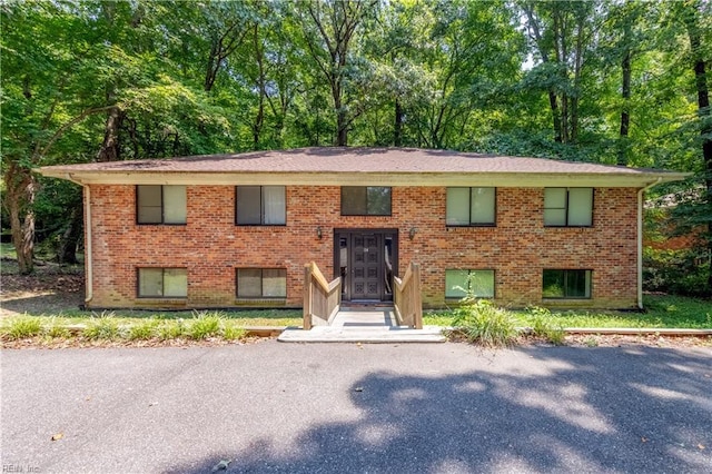 bi-level home featuring brick siding