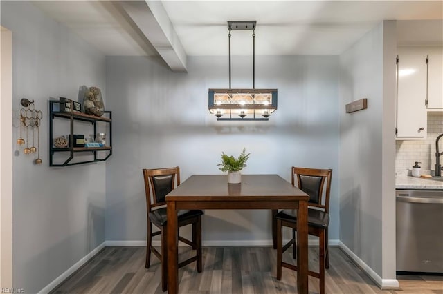 dining area featuring baseboards and wood finished floors