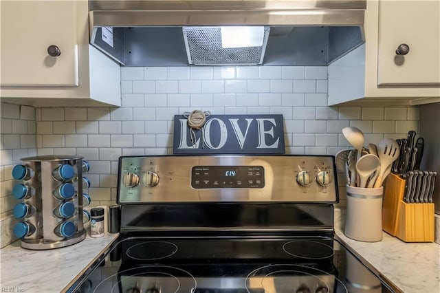 kitchen featuring white cabinets, electric stove, range hood, and tasteful backsplash