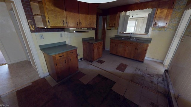 1233 Transylvania Ave, Chesapeake, VA 23324 - kitchen with a sink, range hood, brown cabinetry, and baseboards